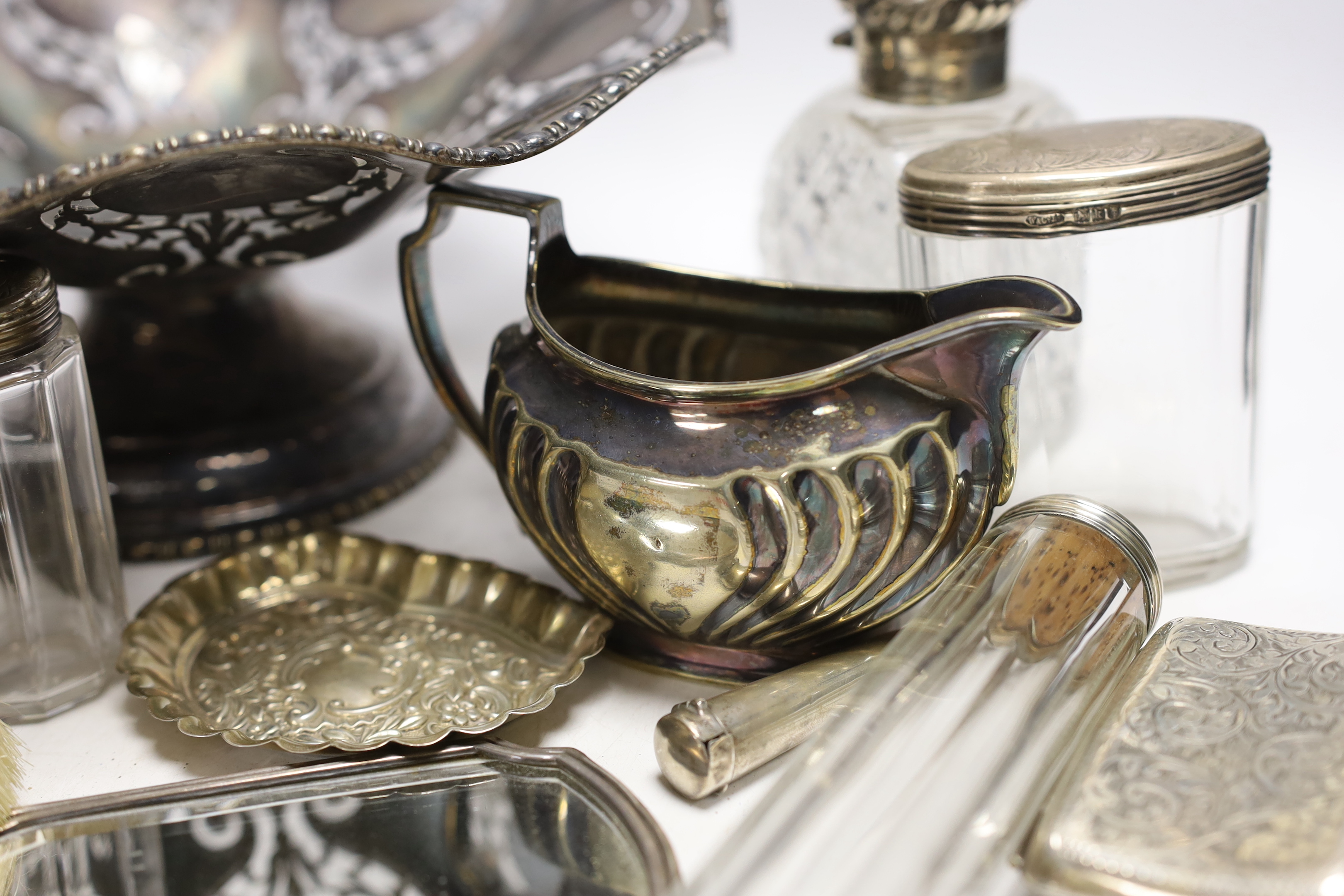 Small silver items including a pair of silver mounted cut glass scent bottles small bowl, toilet jars, mirror, brushes, cigarette case, stamp case, cream jug etc. and two plated items.